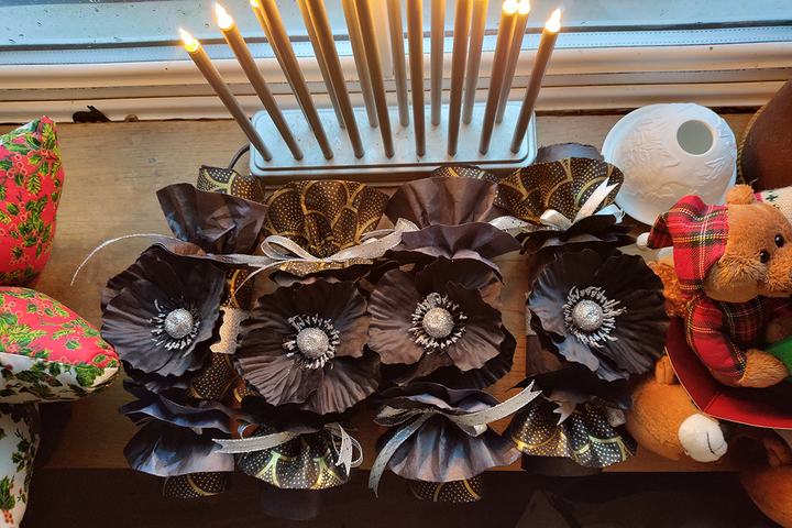 black christmas crackers with large black poppies and fair trade plack paper