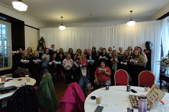 group of people holding up crackers they have made