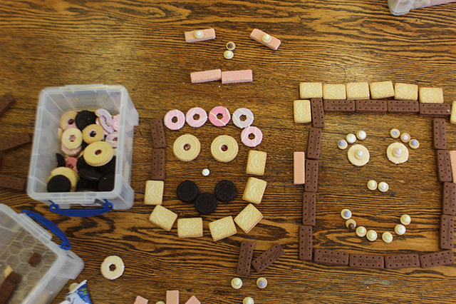 biscuits made into faces on a wooden table